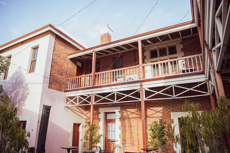 External photo of pink and brown brick building