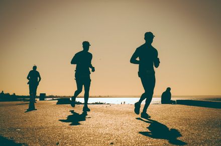 Athletes running as the sunsets