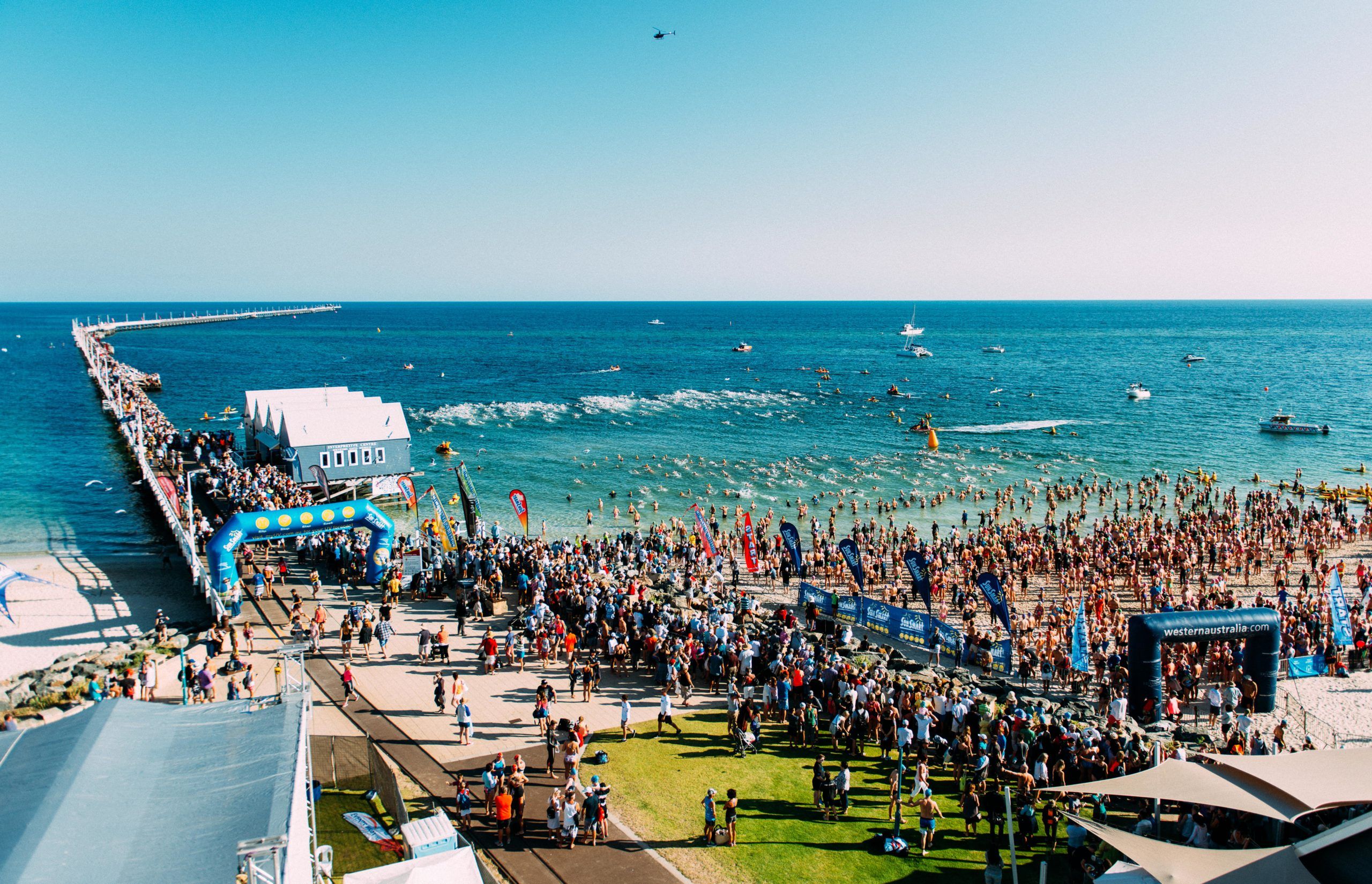 Aerial shot of swimmers and spectators with Busselton Jetty for the Busselton Jetty swim