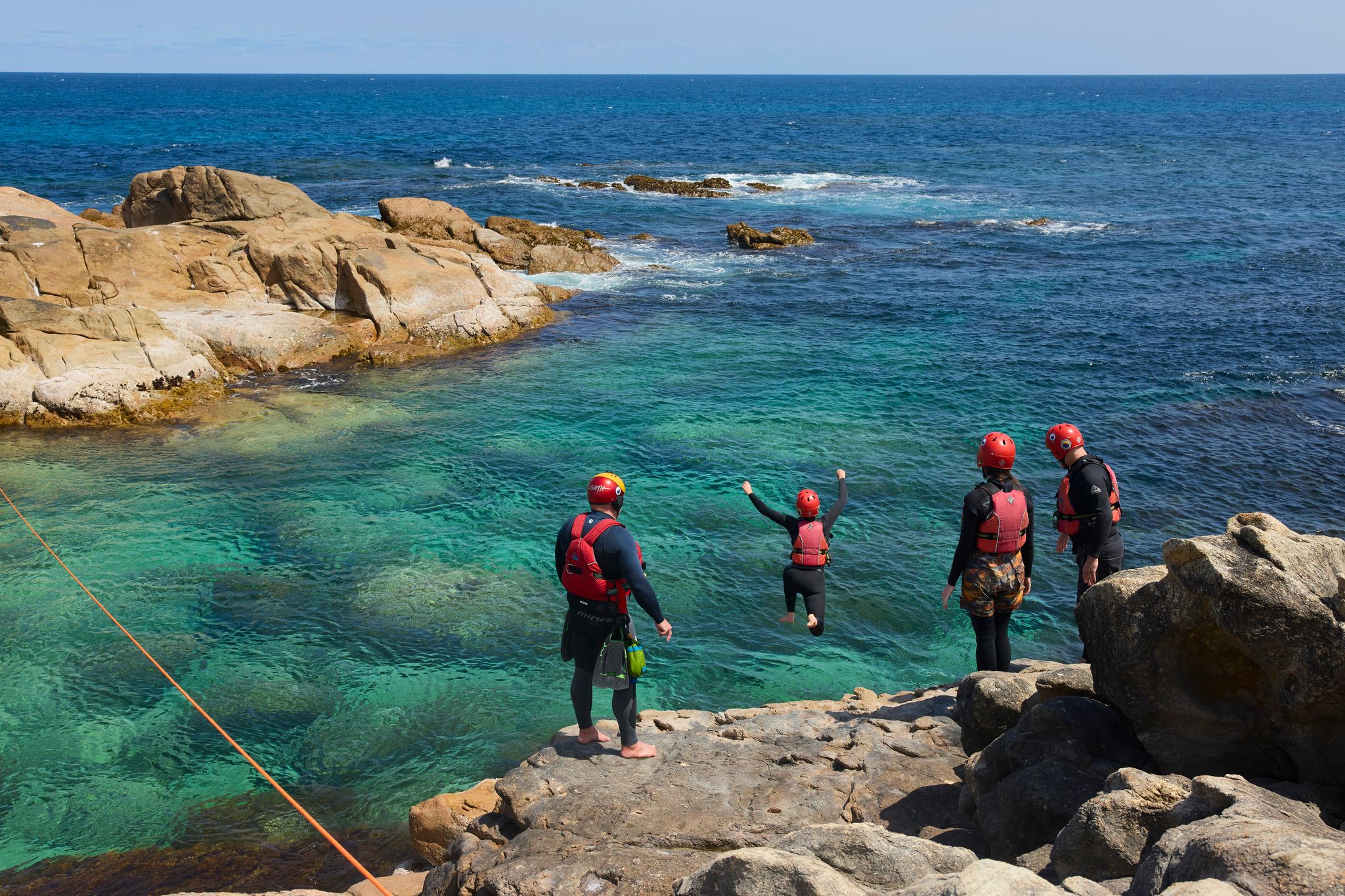 Person jumping into rock pool (coasteering) with Margaret River Adventure Company. Photo credit Tim Campbell.