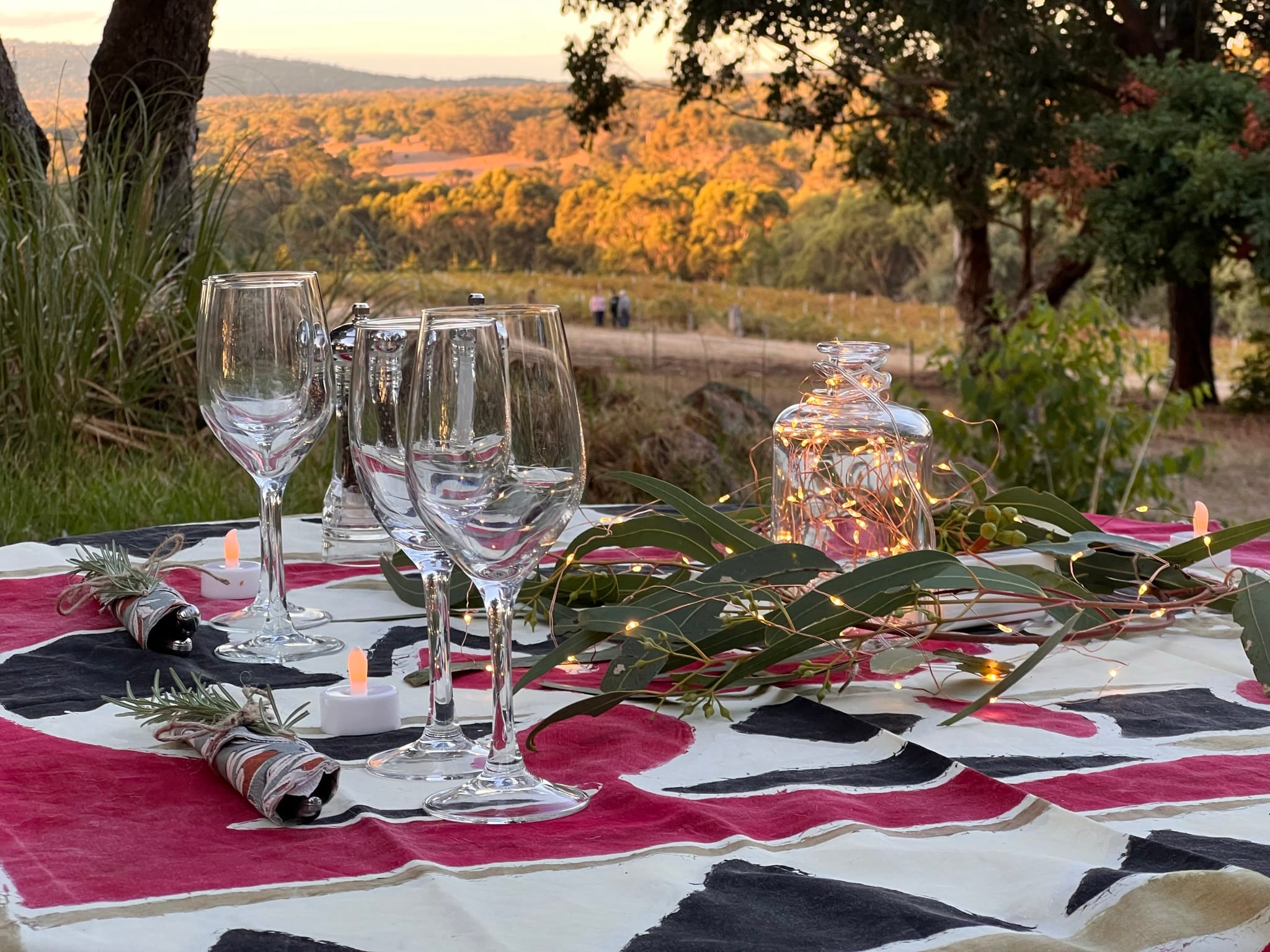 Picnic and wine at sunset overlooking the vines and hills
