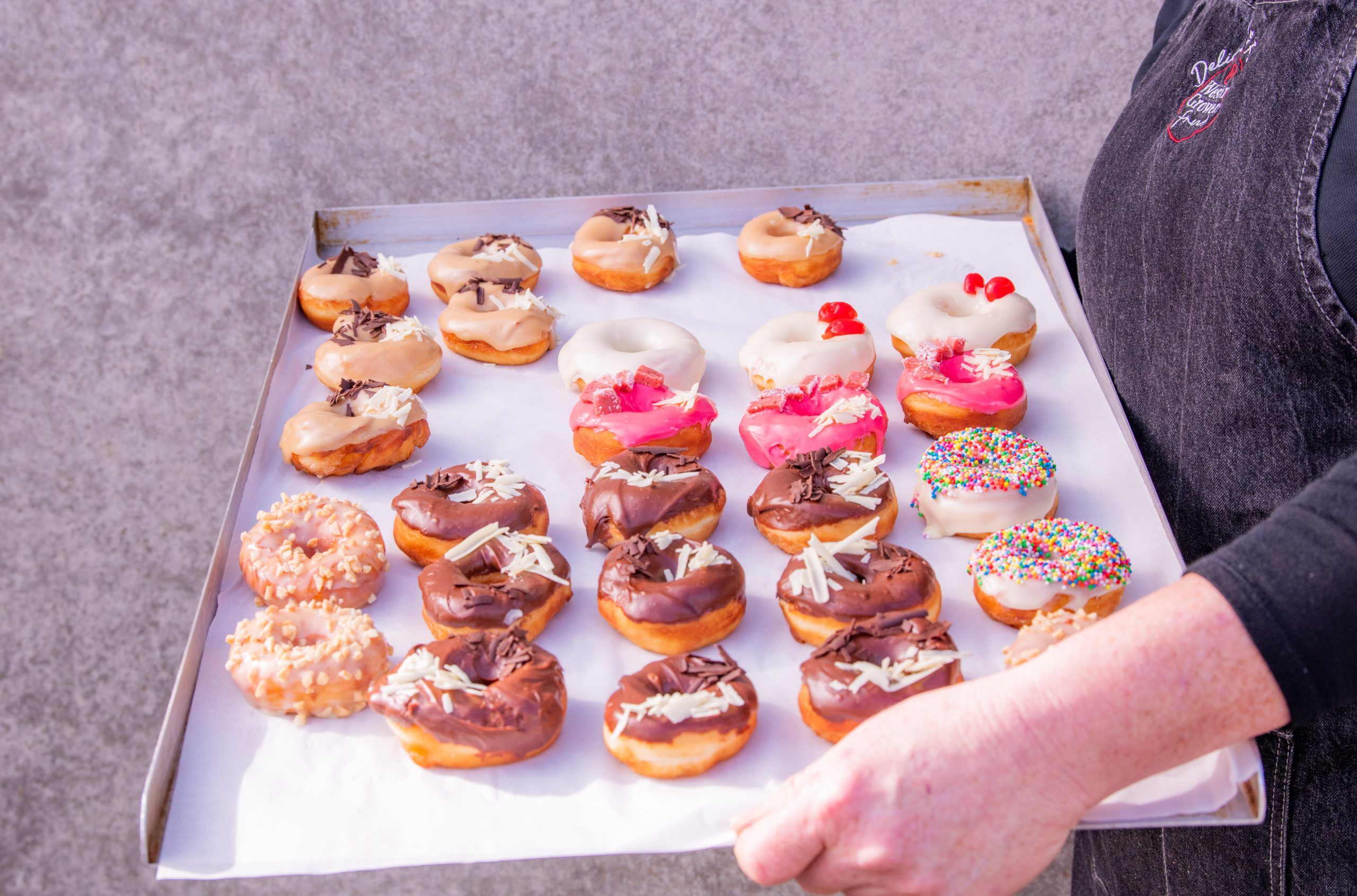 A tray of freshly baked, pink donuts made at Western Growers Fresh, Busselton