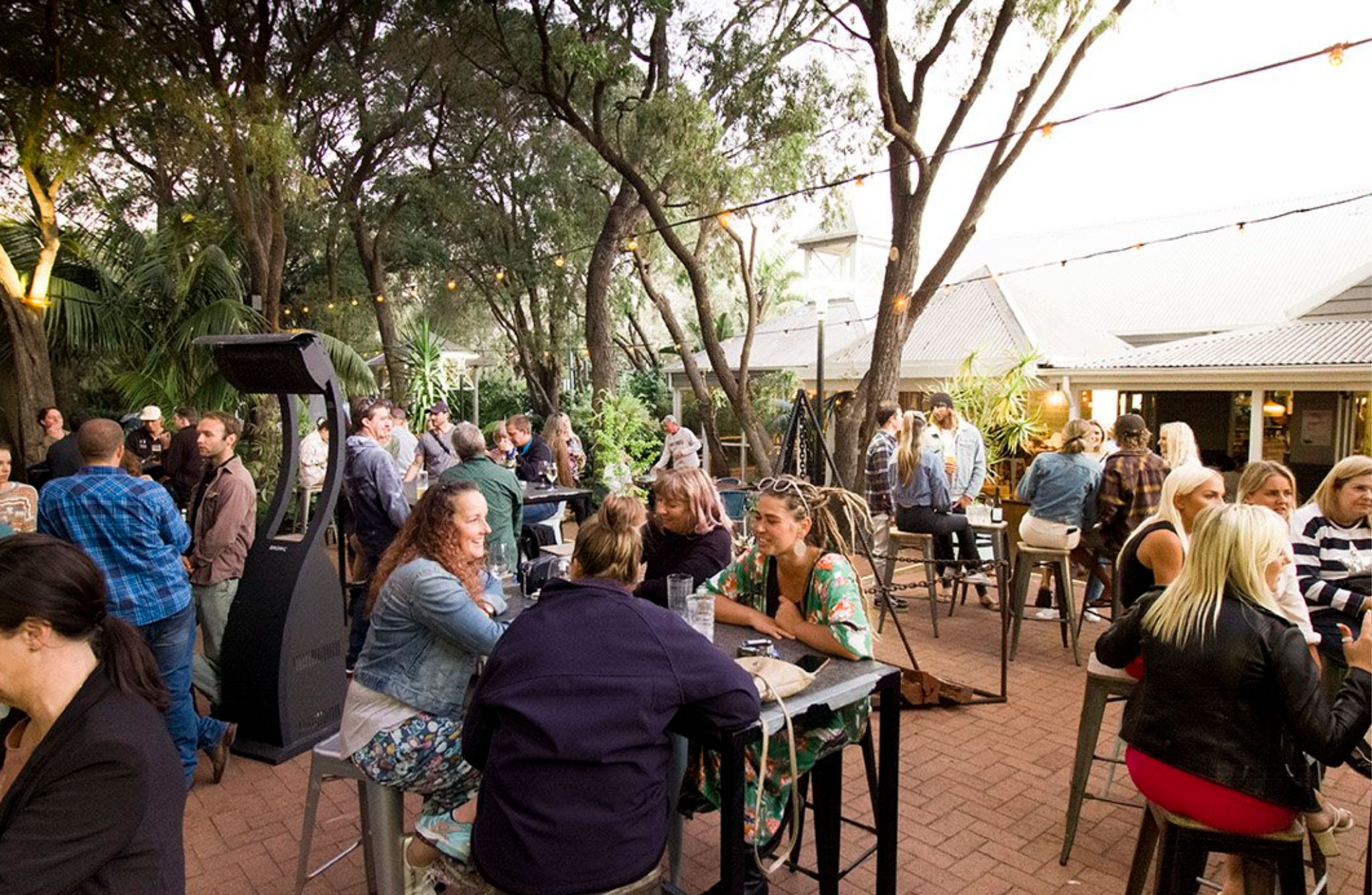 Catch ocean glimpses in between sips through peppermint trees out in the beer garden.