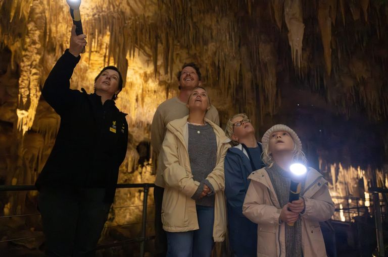 A family and cave guide in Mammoth Cave after dark on a Megafauna Nightstalk.