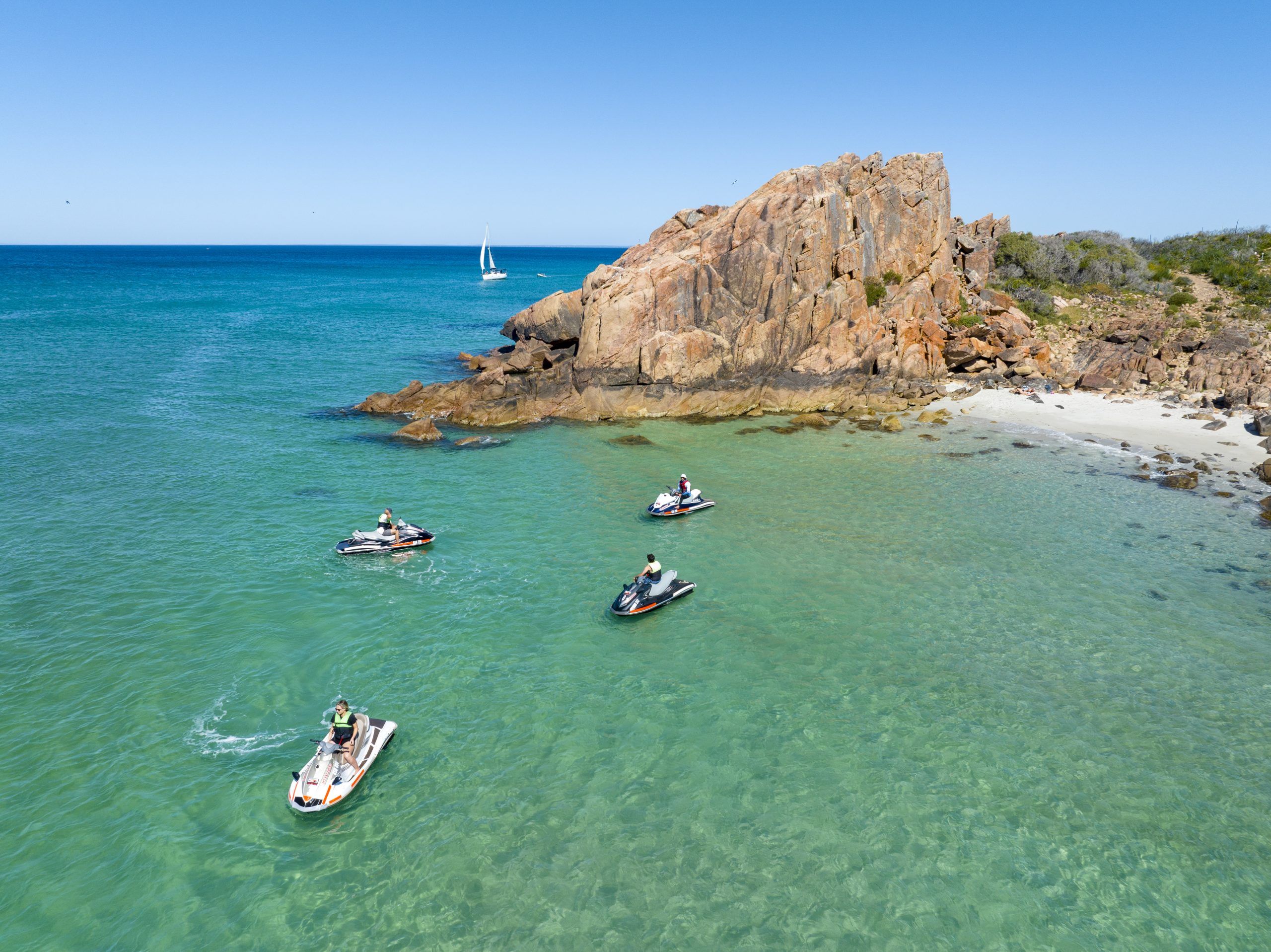 People on jet skis in the ocean.