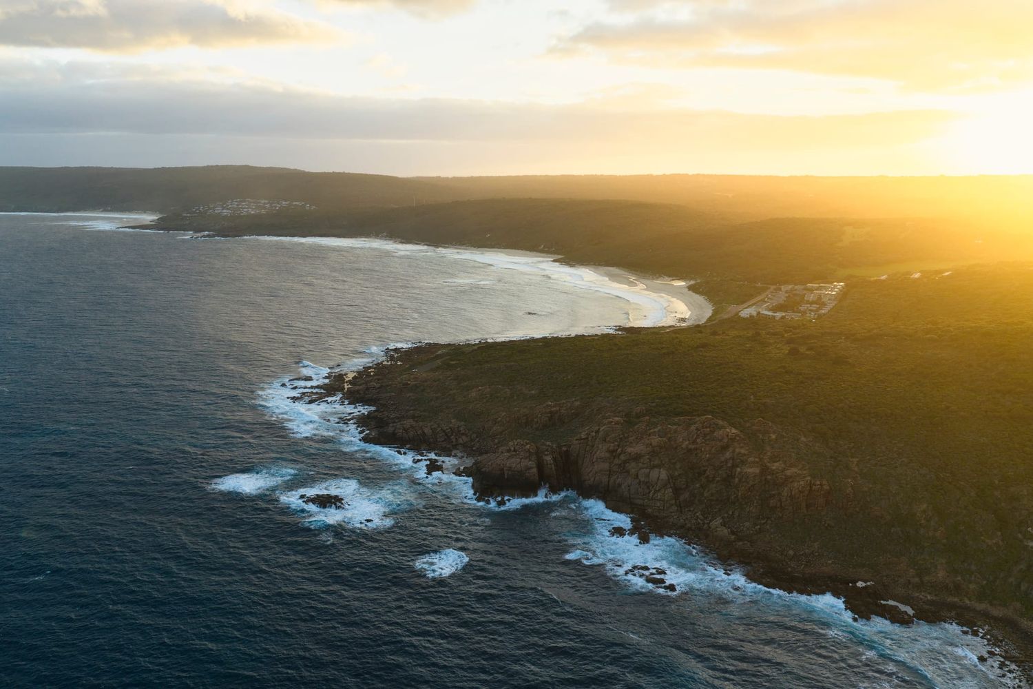 Aerial photo of Smiths beach and Yallingup beach as the sun rises over the land