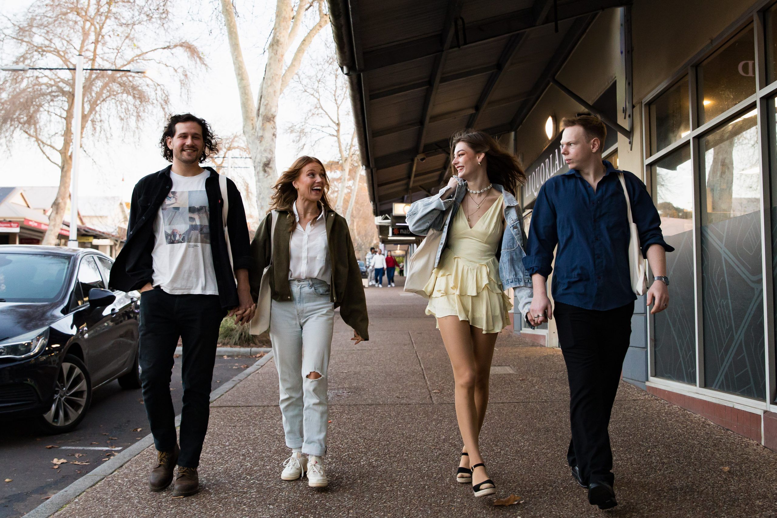 People laughing while walking down the main street of Margaret River.