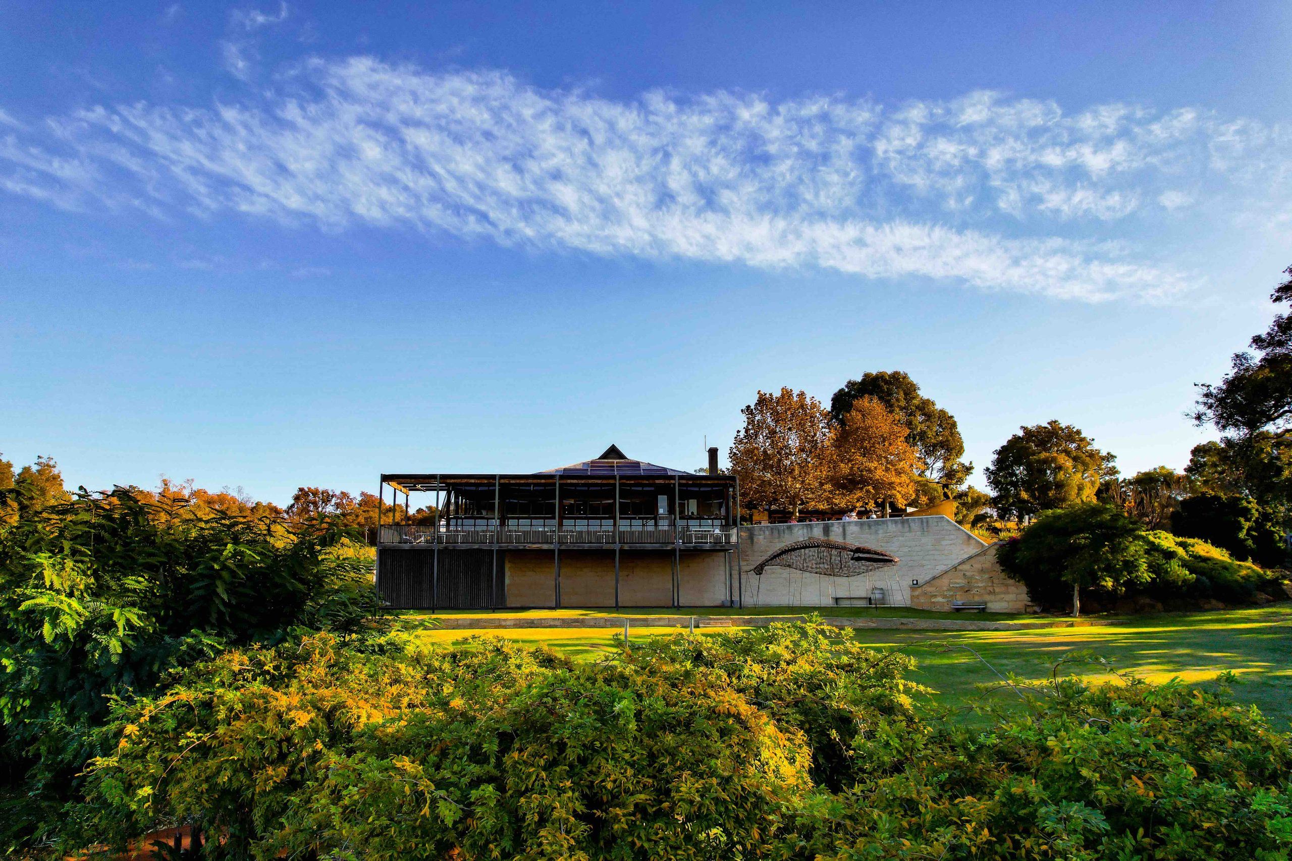 Photo of winery with green grass and blue skys