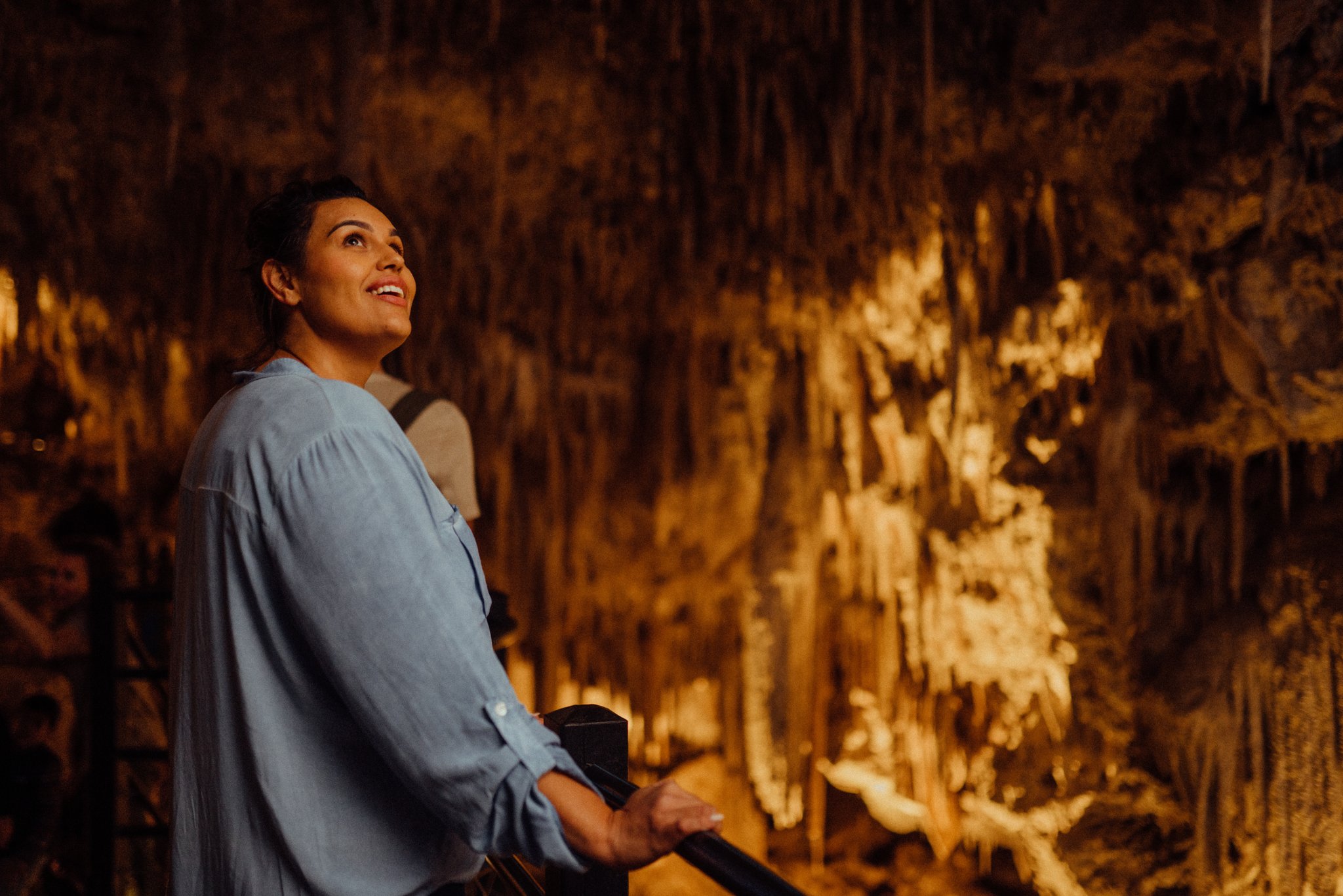 Person in awe looking at the features in Ngilgi Cave