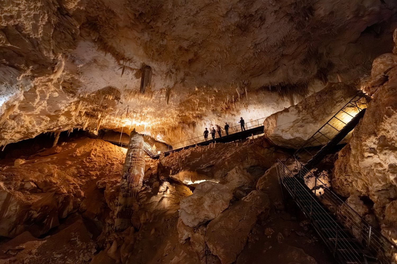 A tour group walking along a boardwalk in Jewel Cave